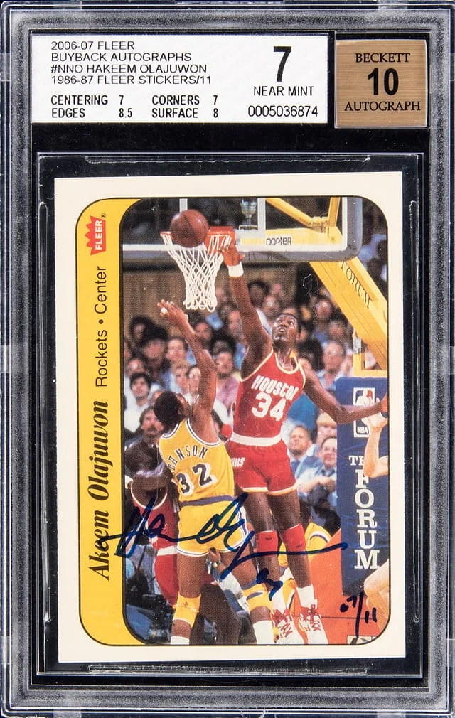2006-07 Fleer Hakeem Olajuwon Buyback Autographs 1986-87 Fleer Stickers #9 card image