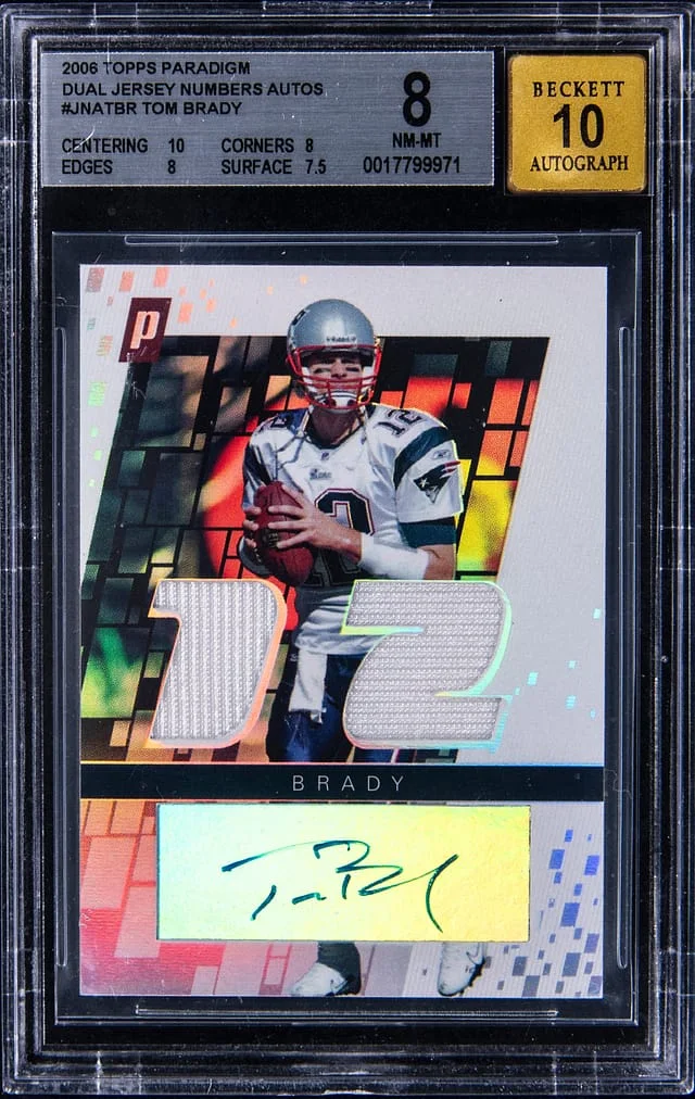 2006 Topps Tom Brady Paradigm Dual Jersey Numbers Autograph #JNA-TBR card image