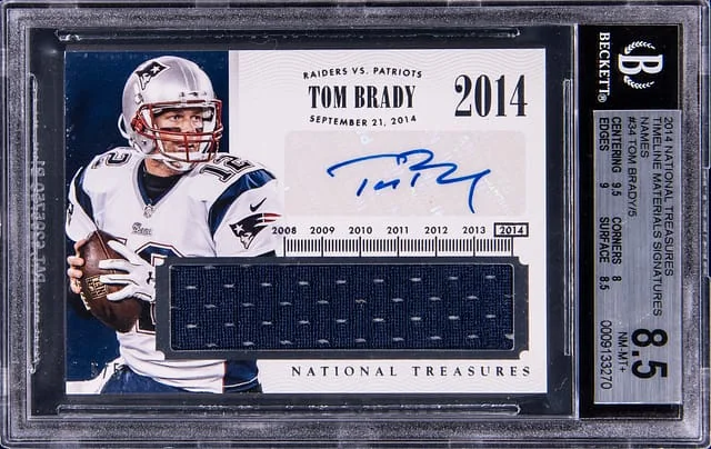 2014 Panini National Treasures Tom Brady Timeline Material Signatures Names #TNM-TD card image