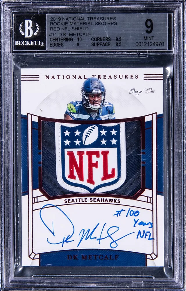 2019 Panini National Treasures DK Metcalf Material Signature RPS Red NFL Shield #RMS-DK card image