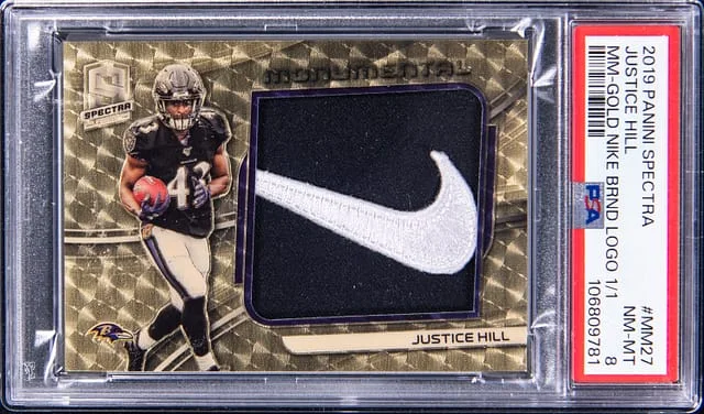 2019 Panini Spectra Justice Hill Monumental Memorabilia Gold Nike Brand Logo #MM-27 card image