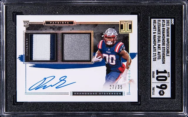 2021 Panini Impeccable Rhamondre Stevenson Elegance Dual Materials Autograph Helmet & Nameplate #136 card image