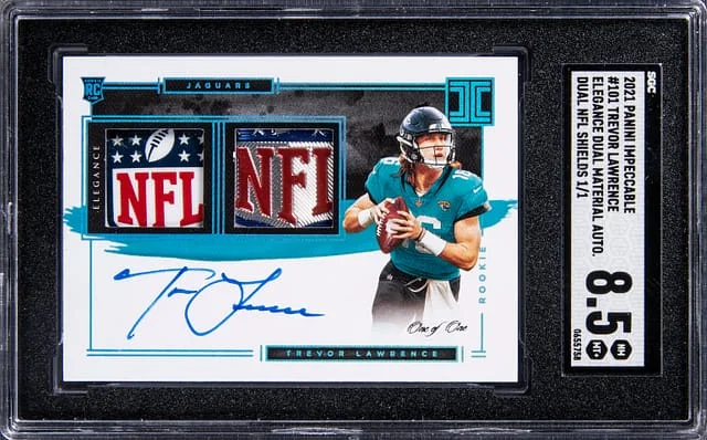 2021 Panini Impeccable Trevor Lawrence Elegance Dual Material Autographs Dual NFL Shields #101 card image