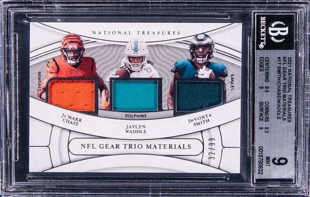 2021 Panini National Treasures Ja'Marr Chase/Jaylen Waddle/Devonta Smith NFL Gear Trio Materials #TM-JJO card image