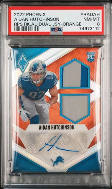 2022 Panini Aidan Hutchinson Phoenix Patch Signatures Auto Dual Jersey Orange #RADAH card image