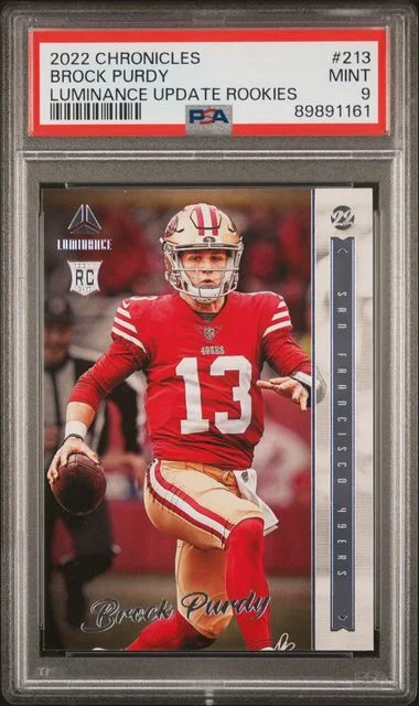 2022 Panini Chronicles Brock Purdy Luminance Update Rookies #213 card image