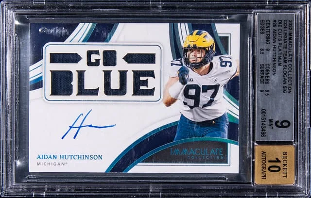 2022 Panini Immaculate Collection Aidan Hutchinson Collegiate Team Slogan Signatures Die Cut Platinum #DC-AHU card image