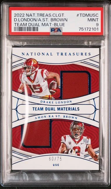 2022 Panini National Treasures Collegiate Team Dual Materials Blue Tdmusc Amon-Ra St. Brown/Drake London #no-number card image