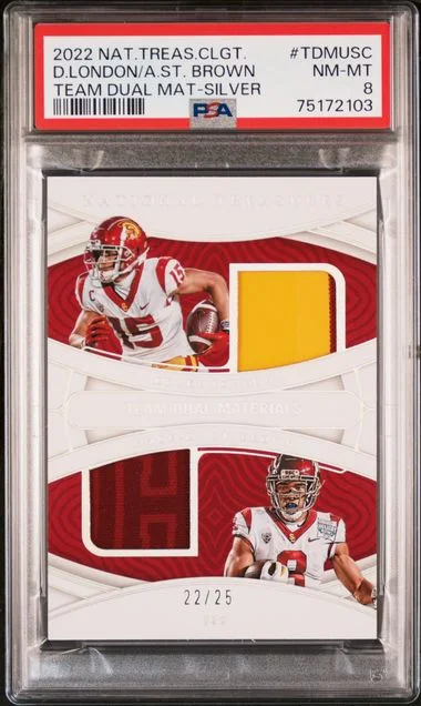 2022 Panini National Treasures Collegiate Team Dual Materials Silver Tdmusc Amon-Ra St. Brown/Drake London #no-number card image