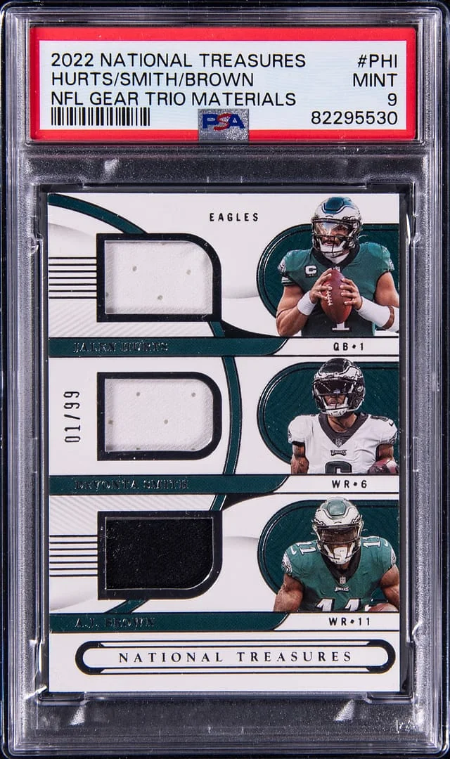2022 Panini National Treasures Jalen Hurts/DeVonta Smith/A.J. Brown NFL Gear Trio Materials #GTM-PHI card image