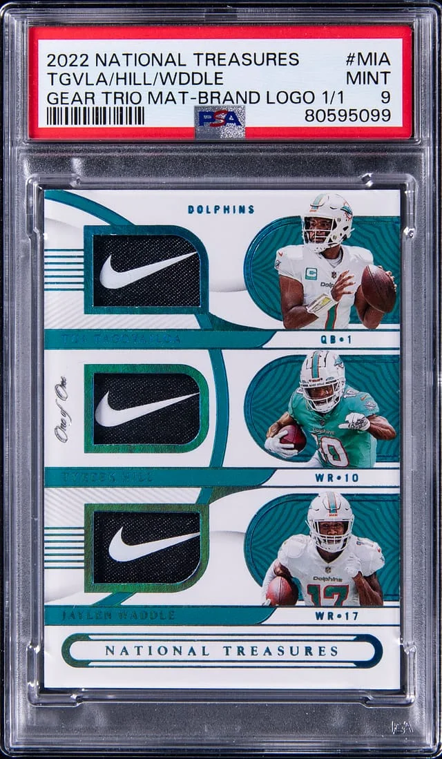 2022 Panini National Treasures Jaylen Waddle/Tua Tagovailoa/Tyreek Hill NFL Gear Trio Materials Brand Logo #GTM-MIA card image