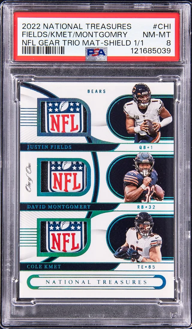 2022 Panini National Treasures Justin Fields/Cole Kmet/David Montgomery NFL Gear Trios Materials NFL Shield #GTM-CHI card image