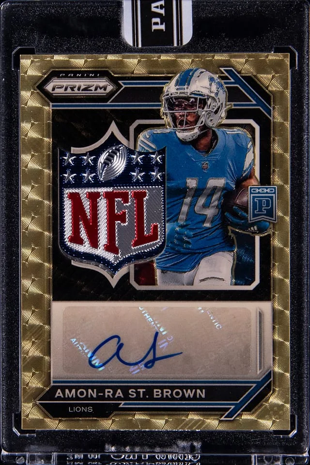 2023 Panini Prizm Amon-Ra St. Brown Blockchain NFL Shield Autographs #NSA-AR card image