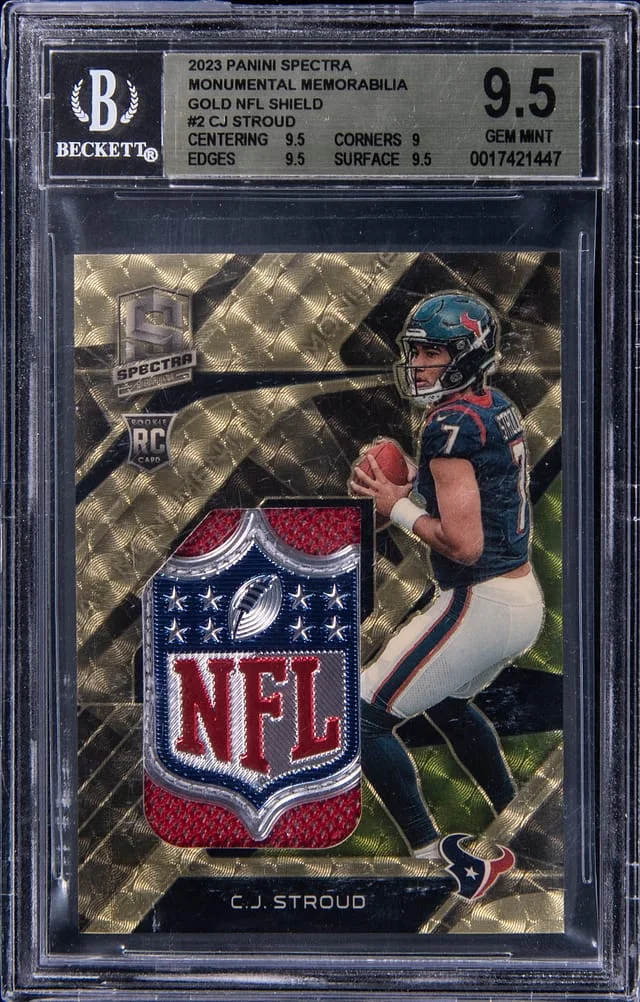 2023 Panini Spectra C.J. Stroud Monumental Memorabilia Gold NFL Shield #MME-CJS card image