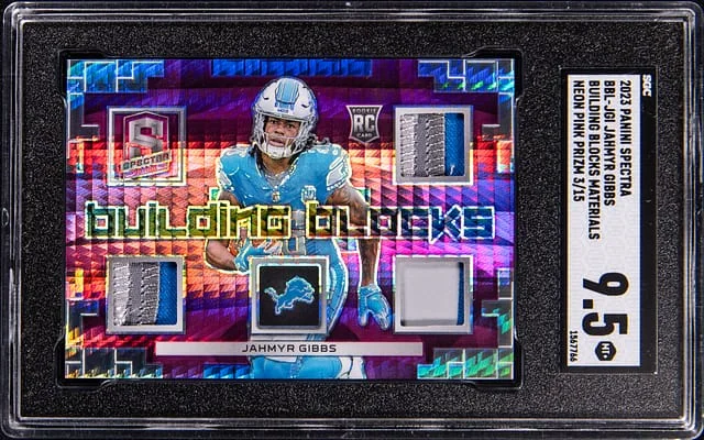 2023 Panini Spectra Jahmyr Gibbs Building Blocks Materials Neon Pink Prizm #BBL-JGI card image